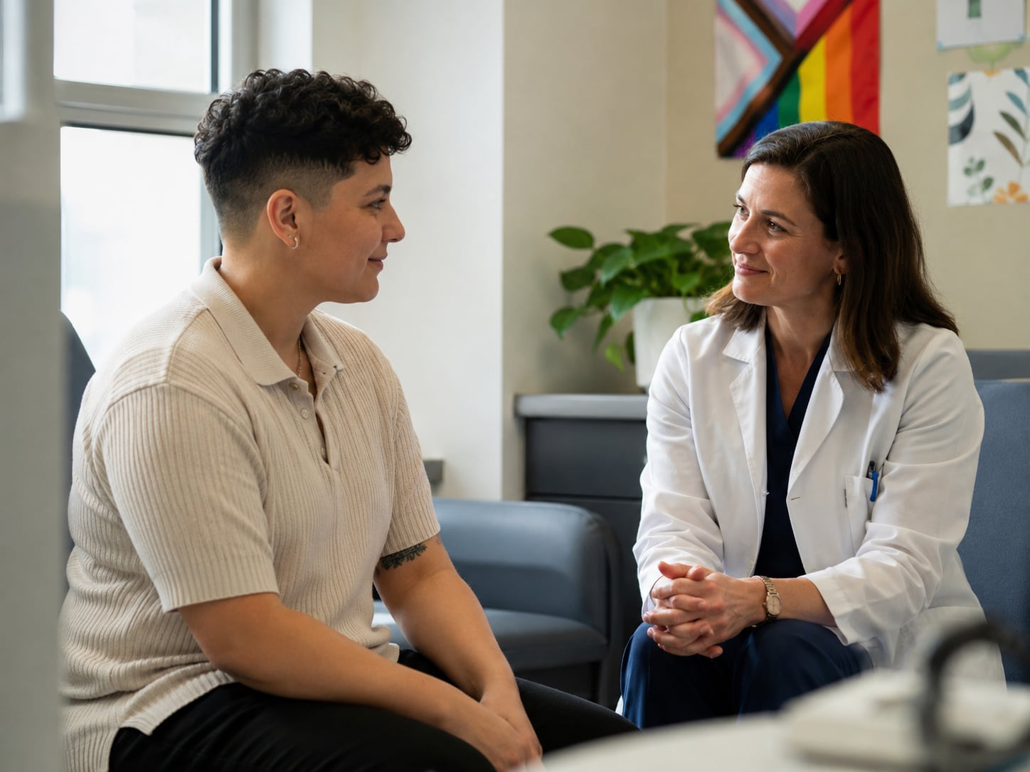 A young man talks with a female clinician or counselor while seated