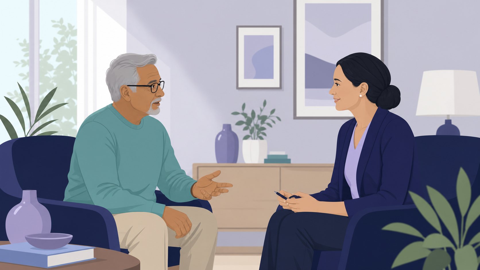 An older adult and an independent counselor talk together in a living room.