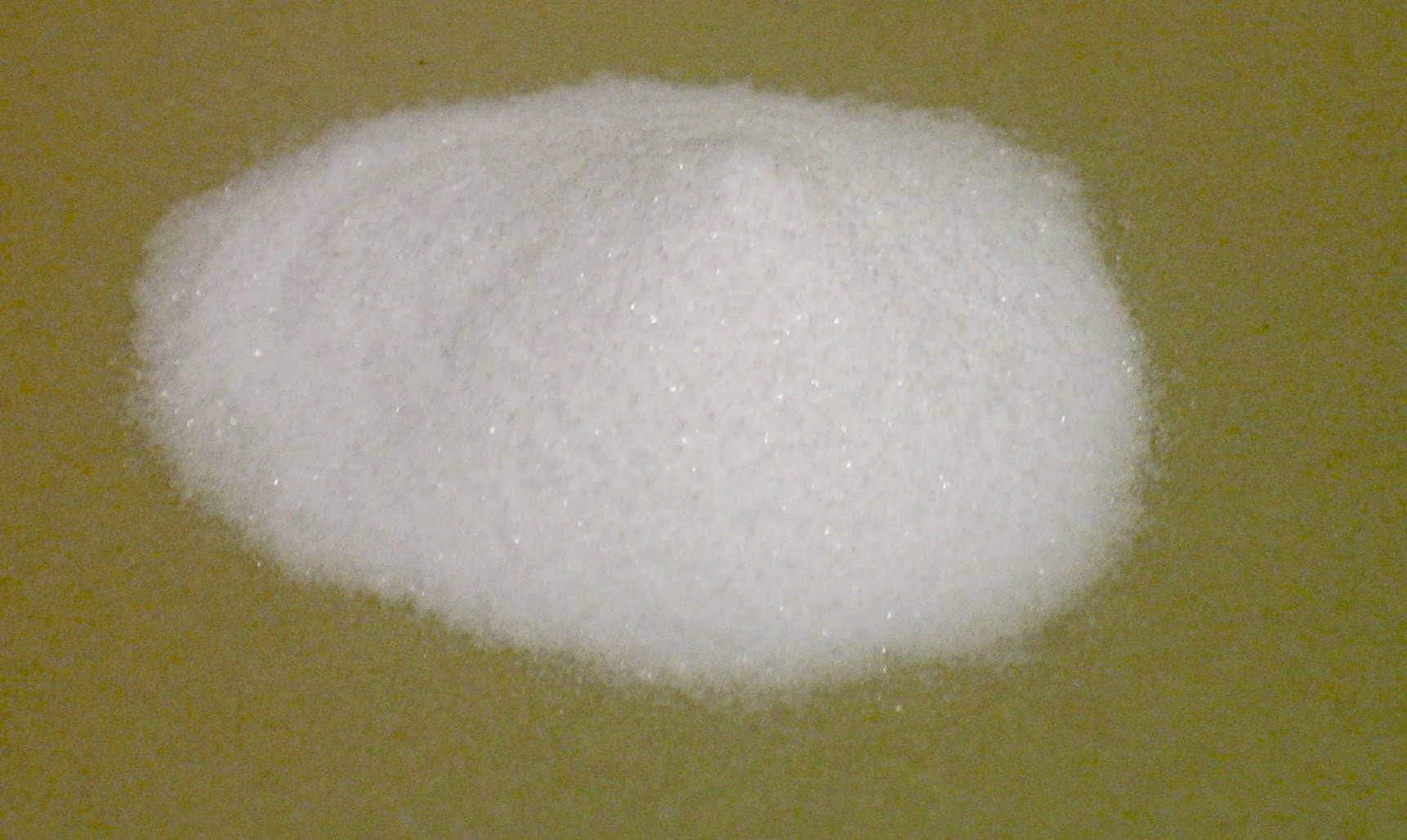 A pile of fine white powder on a tan surface.